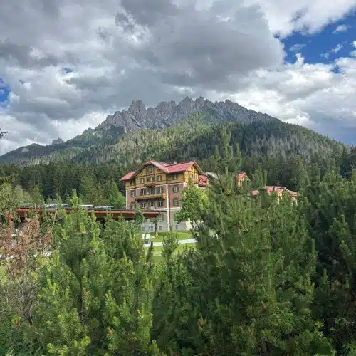 Mountainous landscape with Alta Via 1 lodge in Dolomites